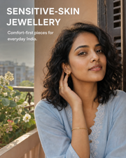 Ektaraa sensitive-skin jewellery blog cover showing a modern Indian woman on a Kolkata balcony wearing gold-tone huggie earrings, bracelet and ring.